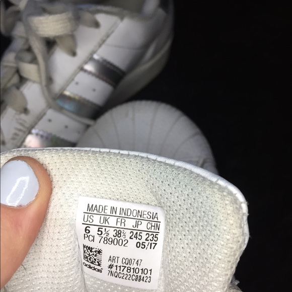 white adidas with holographic stripes